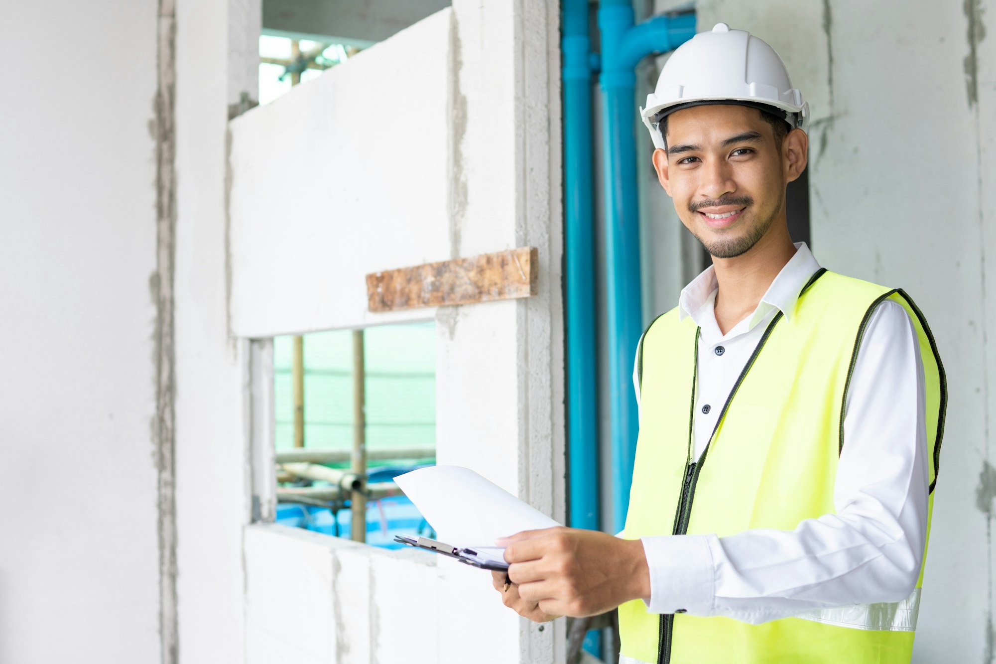 Inspector holding clipboard opening paper and checking building for renovation, Home inspection